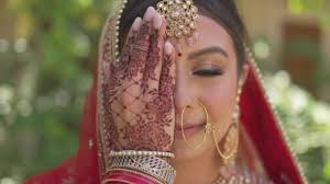 happy indian bride covering her face