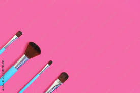 four blue makeup brushes