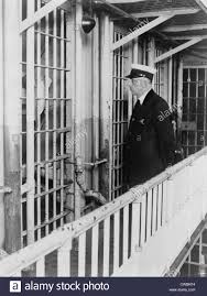 A Prison Guard At The Cook County Jail Standing Outside The Cell Of