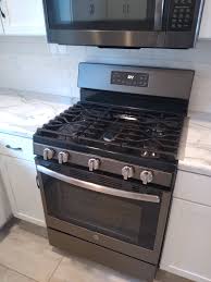 A downdraft range hood is a ventilation system that's built into either the cooktop or countertop, behind the cooktop burners. Heat Damage To Laminate Counter Top Near Gas Range Home Improvement Stack Exchange