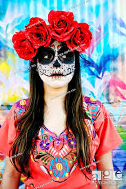 hispanic woman wearing skull face paint