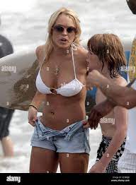 Lindsay Lohan goes down the beach to call in her little brother Cody  (Dakota) who has strayed out into the ocean on his surf board while she  celebrates Independence Day at the