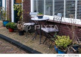 Garden Furniture On Porch Of House With