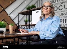 mature adult woman head with gray hair in the office Stock Photo - Alamy