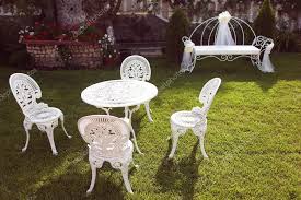 White Cast Iron Chairs And Table In The