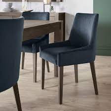 Make mealtimes more inviting with comfortable and attractive dining room and kitchen chairs. Ella Dark Oak Scoop Back Chair Dark Blue Velvet Fabric Bentley Designs