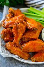 baked buffalo wings tossed in hot sauce served with celery sticks
