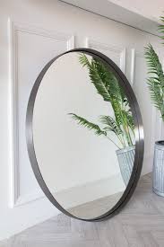 large round mirror with brushed steel