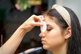 makeup artist covers female eye