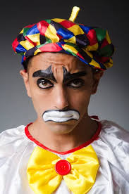 sad clown against dark background