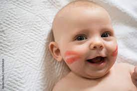 baby covered in lipstick kisses stock