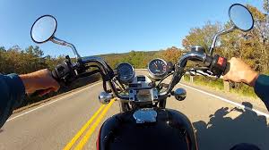 pov motorcycle riding on tree lined