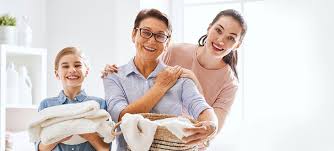 a couple smiling and a basket of clothes