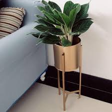 Standing planters are interesting because they showcase and display the plants in a beautiful and almost dramatic manner. Yourstalkmarket Gold Indoor Standing Planter Gardening Pots Planters On Carousell