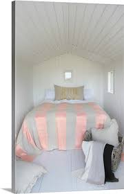bedroom with white wood paneling on the