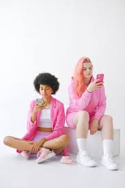 Trendy multiracial teenagers using smartphones in studio · Free Stock Photo