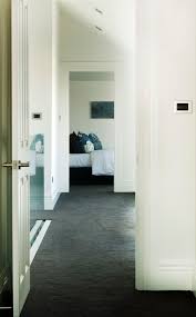 hallway with dark carpet and white