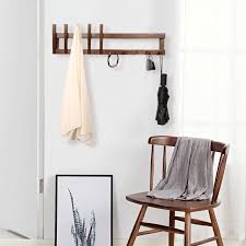 Create an art feature out of a coat rack, with this line of alternating black piano wall hooks: Modern Wall Hooks And Coat Racks With Cool And Interesting Designs