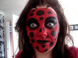 red ladybird face painting you
