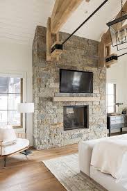 rustic brick fireplace with tv in
