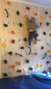 Toddler Scales Climbing Wall Built By