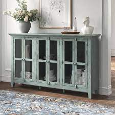 A Distressed Wood Sideboard With Glass