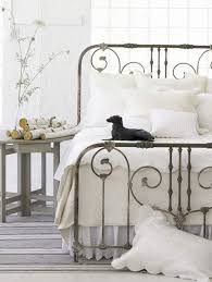 Glass and wrought iron entry doors next to wrought iron bed ideas alongside green curtains and built in wardrobe. White Rooms White Bedroom White Rooms Iron Bed