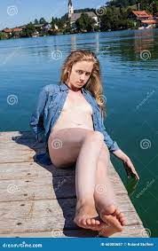 Young Woman Sunbathing Nude on Lake Dock Stock Image - Image of sunbathing,  reclining: 60300687