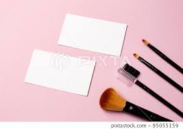 makeup brush and white business card on