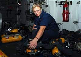 Petty Officer 3rd Class Valerie Malloy refills self-contained breathing  apparatus tanks.