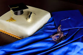 blue graduation gown and cap with cake