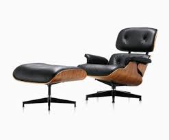 Stylish custom club chair and ottoman having ebonized wood and a mix of black leather and black and white cowhide upholstery, finished with nailheads. Eames Lounge And Ottoman Lounge Chair Herman Miller