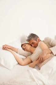 Embracing Couple Sleeping In Bed Stock