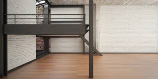 This intermediate floor can help add a certain vibe to the space, illuminating it or defining a new purpose for a different portion of the same space.small rooms can dark walls under a white ceiling split by a mezzanine showcasing a large wooden rail compose a sleek and elegant design match. Increase The Beauty Of The Floors With Mezzanine Flooring