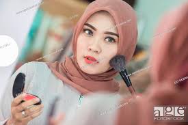 beauty muslim woman with hijab applying