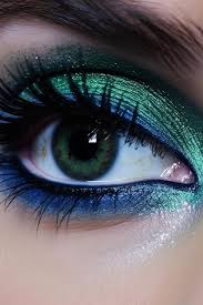 a green eye with blue eyeshadow and