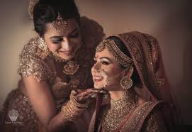 photo of bride posing with sister while