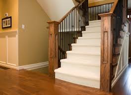 carpeted stair case with hardwood