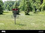Empty red disc golf basket with white Canadian maple leaf on the ...