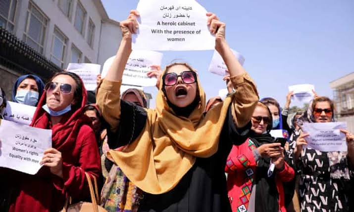 Women march outside a building in Kabul 