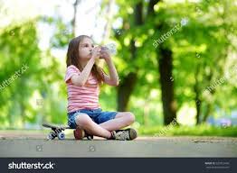Pretty little girl drinking water while sitting on a skateboard outdoors on  beautiful summer day #Ad , #spon… | Pretty little girls, Pretty little,  Beautiful summer