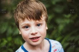 Brown hair and blue eyes is extremely common in the western european countries such as norway, sweden, germany, england, ireland, scotland, and wales. Portrait Of A Smiling Boy With Light Brown Hair And Blue Eyes Stock Photo Offset