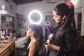 makeup artist spraying hairspray