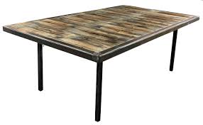 A large rustic table makes a striking centerpiece in the dining room, perfect for capturing the trendy urban farmhouse look. Specialty Tables Party Time Rental Denver Colorado Springs