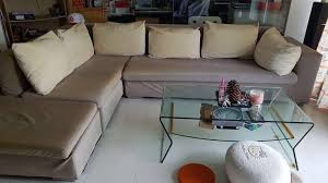 l shaped grey sofa with white cushions