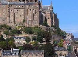 The cluster of historic structures built into the island's rising terrain attract visitors from across the globe. Mont St Michel A Village In Normandy