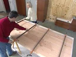 A strip of wax paper acts as a barrier between the wood clamp and the wood. Build A Diy Wood Table How Tos Diy