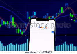 Google Logo Is Seen On An Smartphone Over Stock Chart Stock