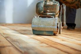 worker polishing parquet floor with