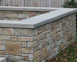 A Block Wall Covered With Natural Stone